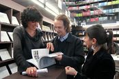 Benedetta Carpi di Resmini, Willy Goldschmidt and Laura Escobar browsing the exhibition catalogue